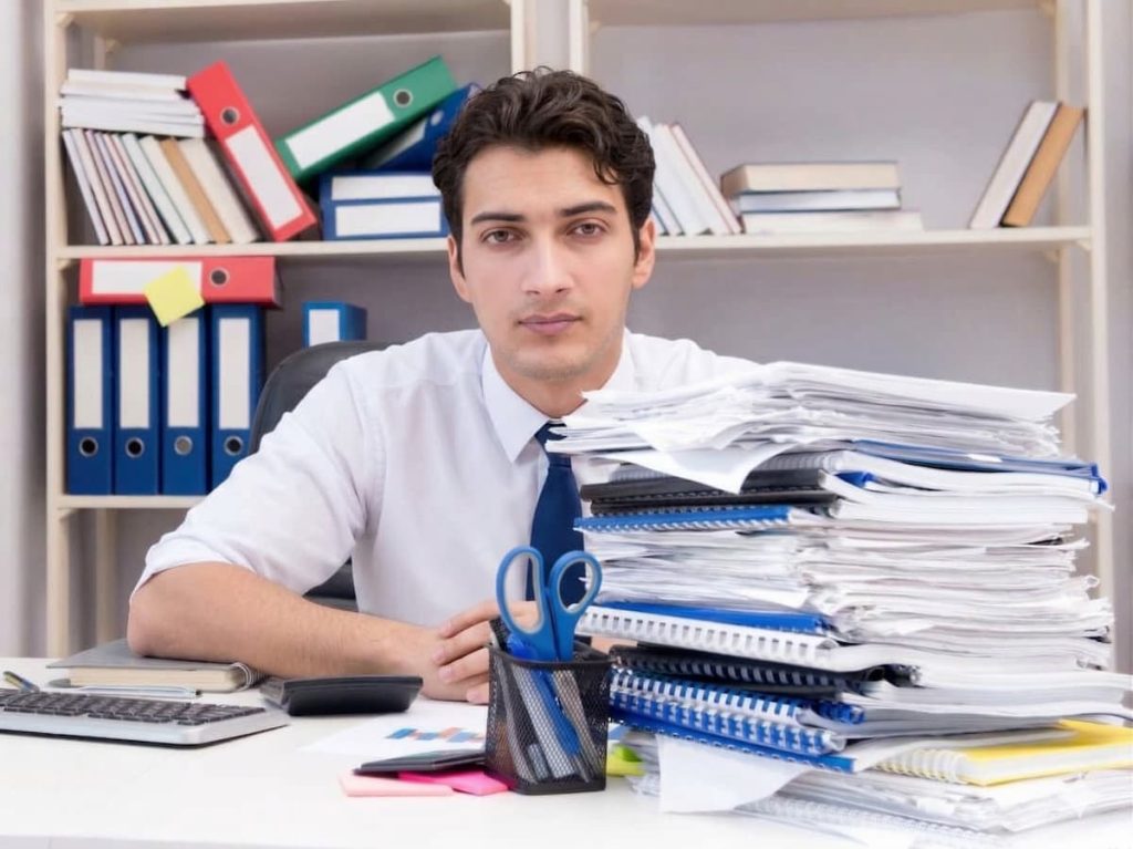 Overloaded office worker in a company in need of an interim CFO.